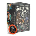 The front of the Bones Coffee Company S’morey Time 12 Count Bones Cups box. Its flavor is s’mores, and it has a skeleton standing up with a flashlight while bigfoot and a werewolf sit nearby beside a campfire on the art.